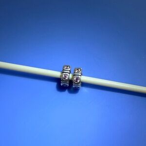 Chamilia set of 2 sterling silver spacer beads with pink cubic zirconia stones.